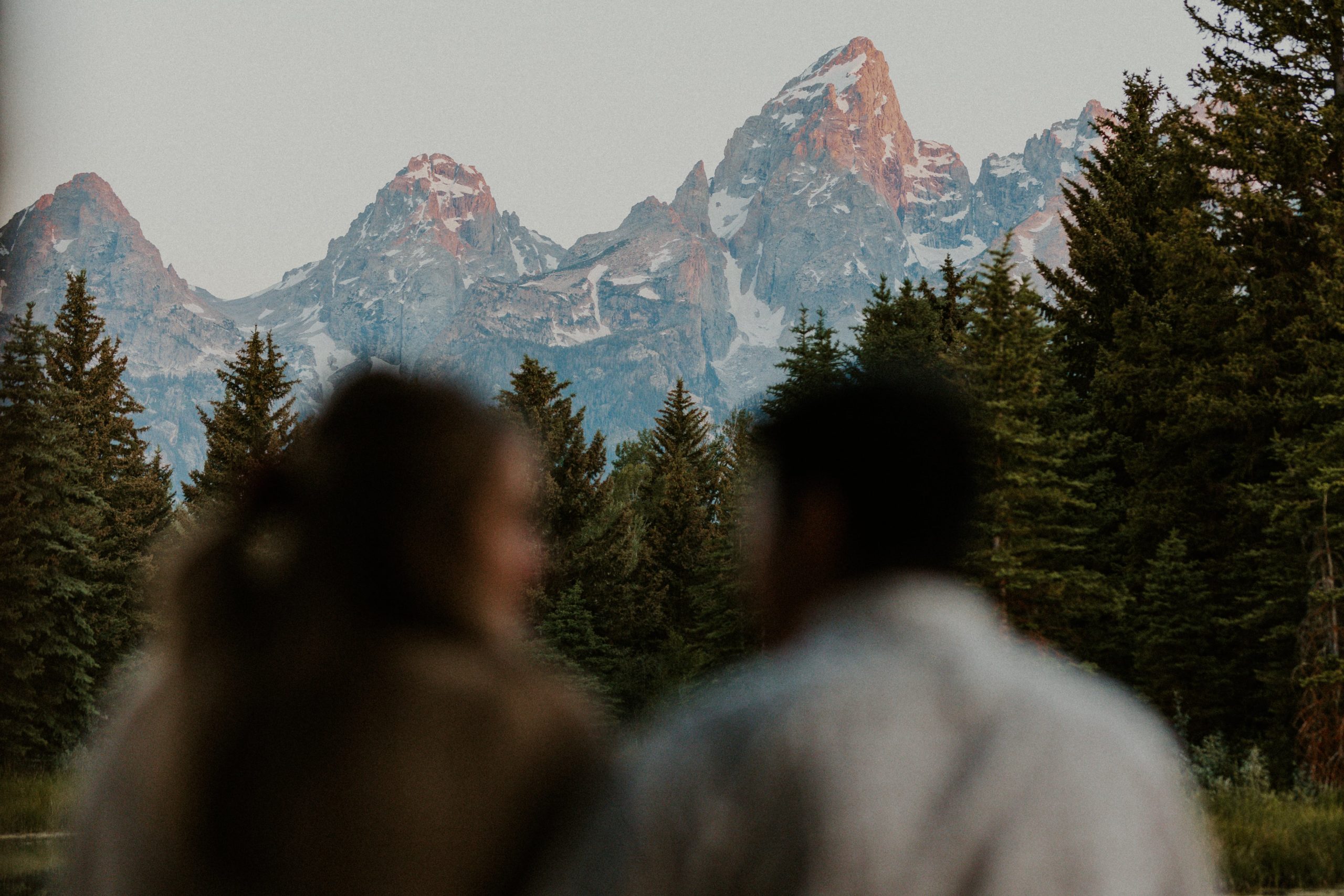 Engagement photos at sunrise at Schwabacher Landing in the Grand Teton National Park.