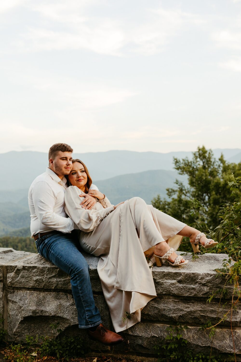 A couple smiles on the Foothills Parkway for an engagement photo in the Great Smoky Mountains.