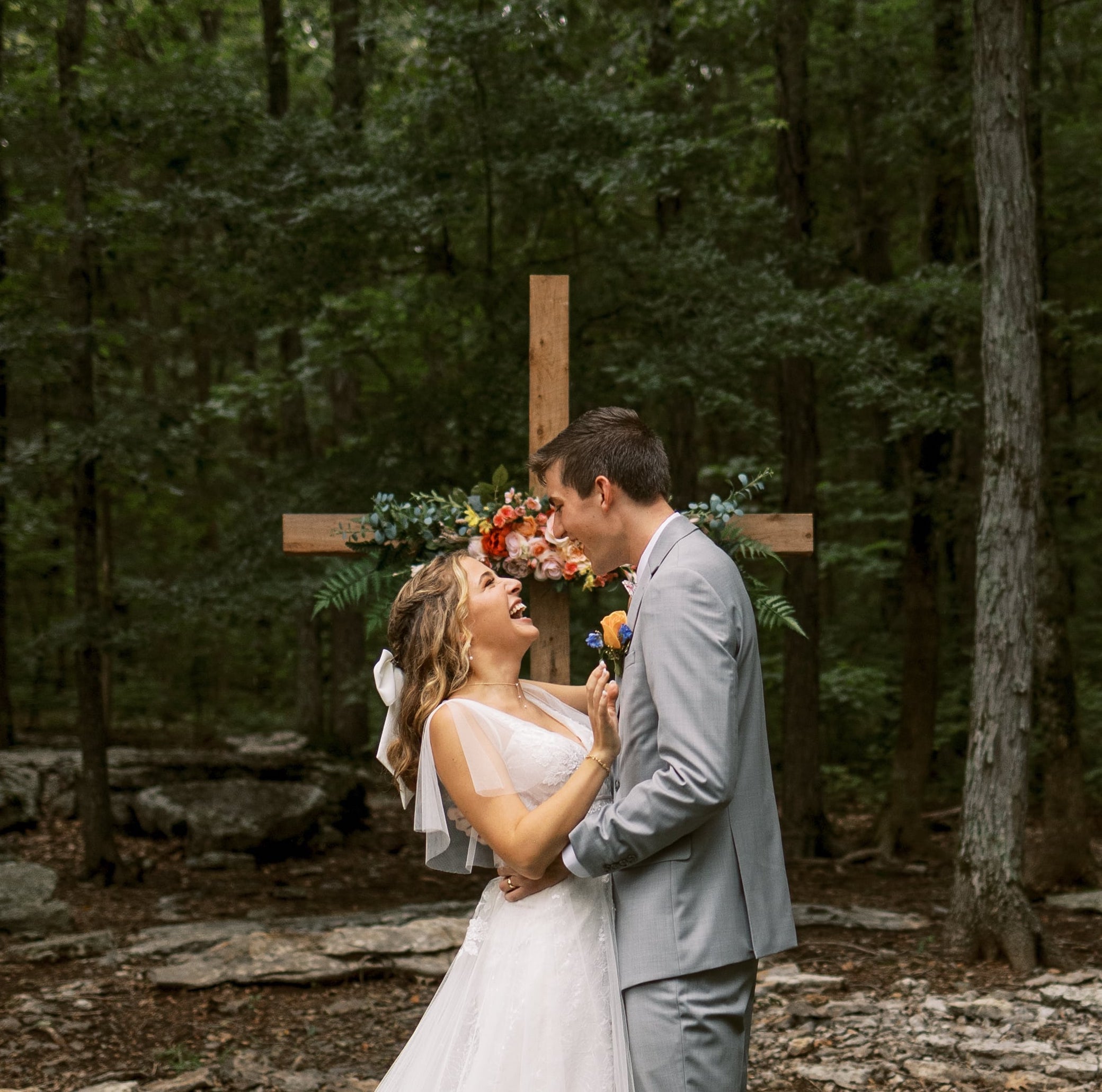 A bride and groom laugh at their summer cottage core wedding in Nashville, Tennessee.