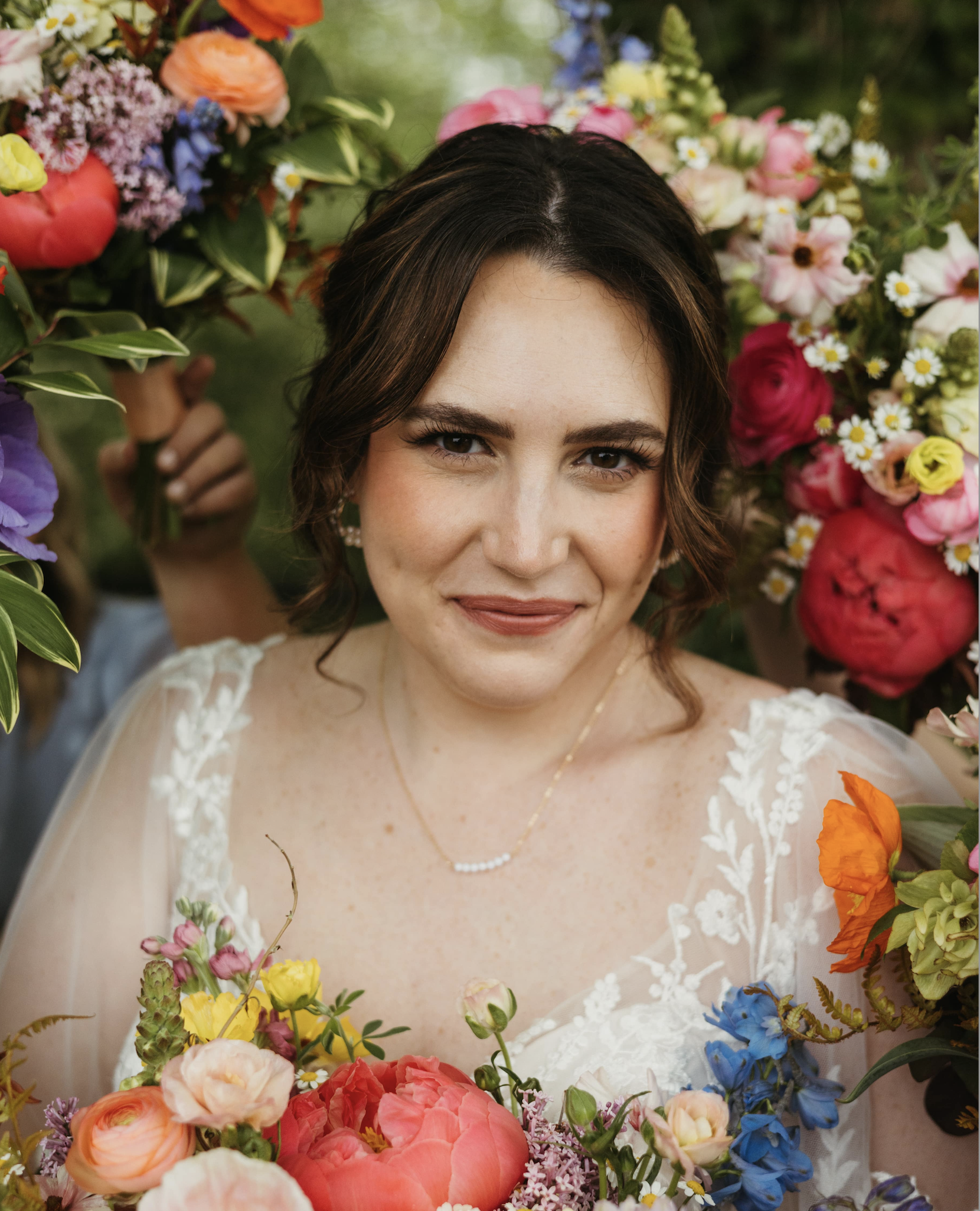 A bride smiles while surrounded by wildflowers at the Stonehouse at Silver Creek in Kentucky.