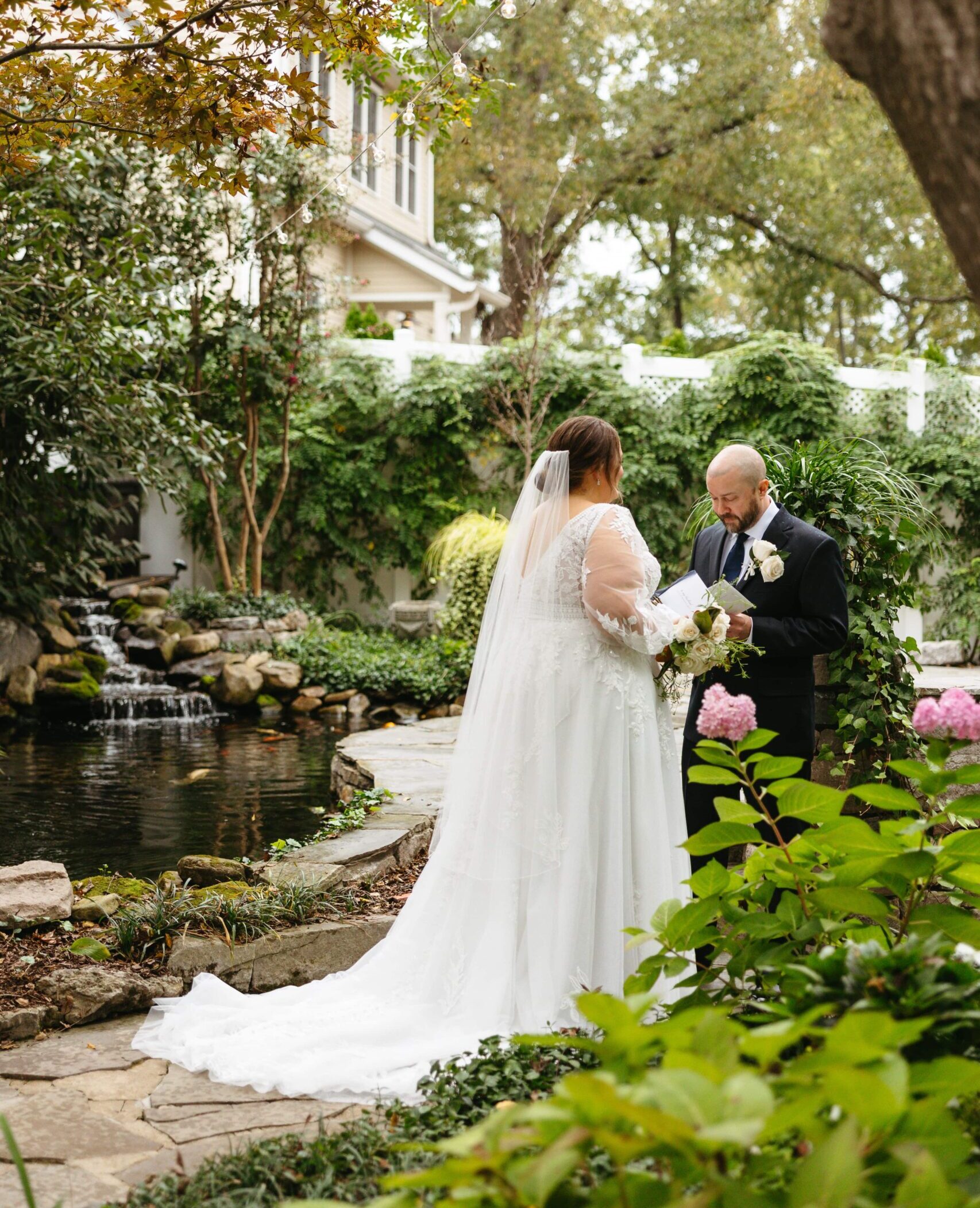 A bride and groom read private vows in the garden at CJ's off the Square in Nashville.