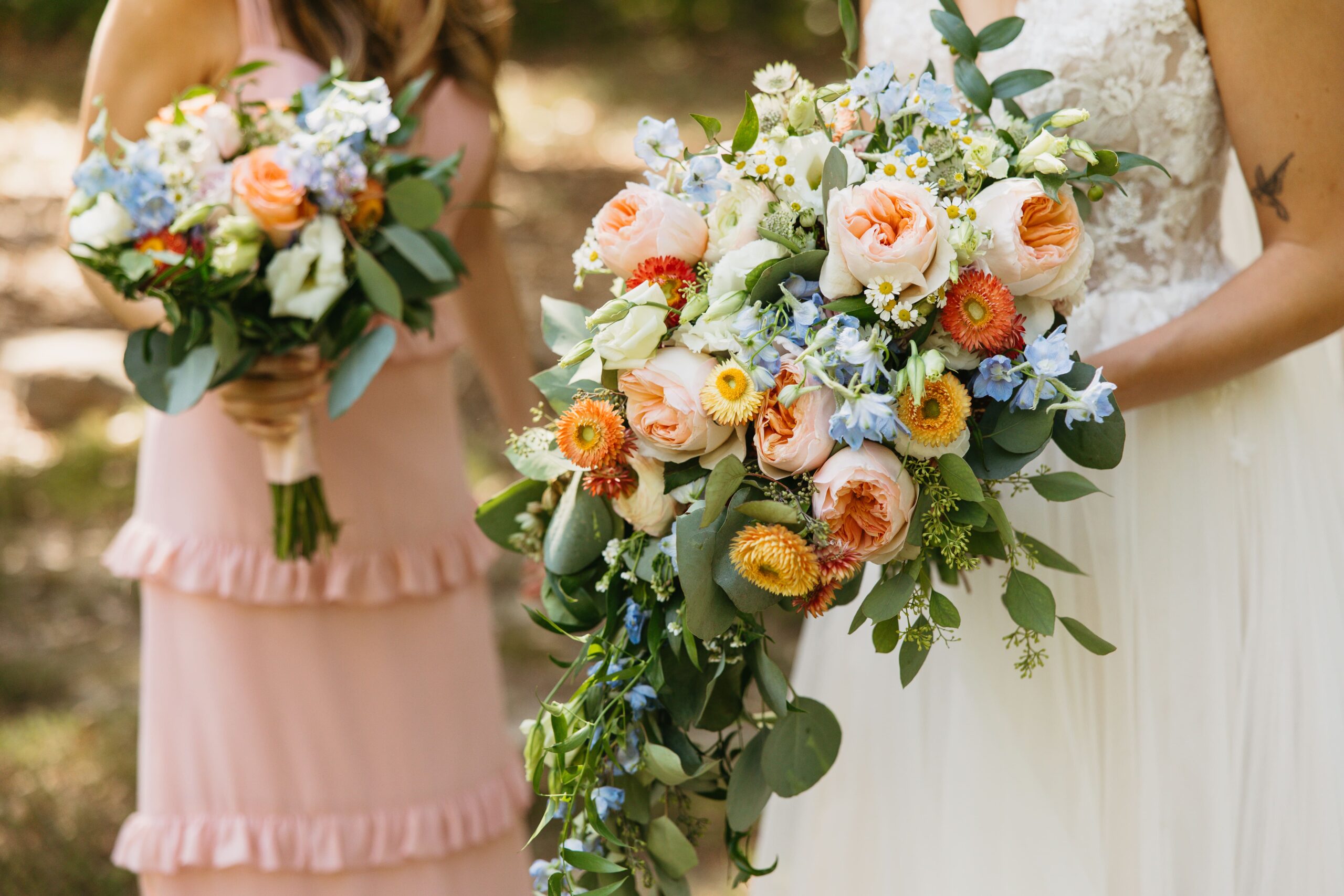 A close up of colorful wedding florals at a backyard wedding.