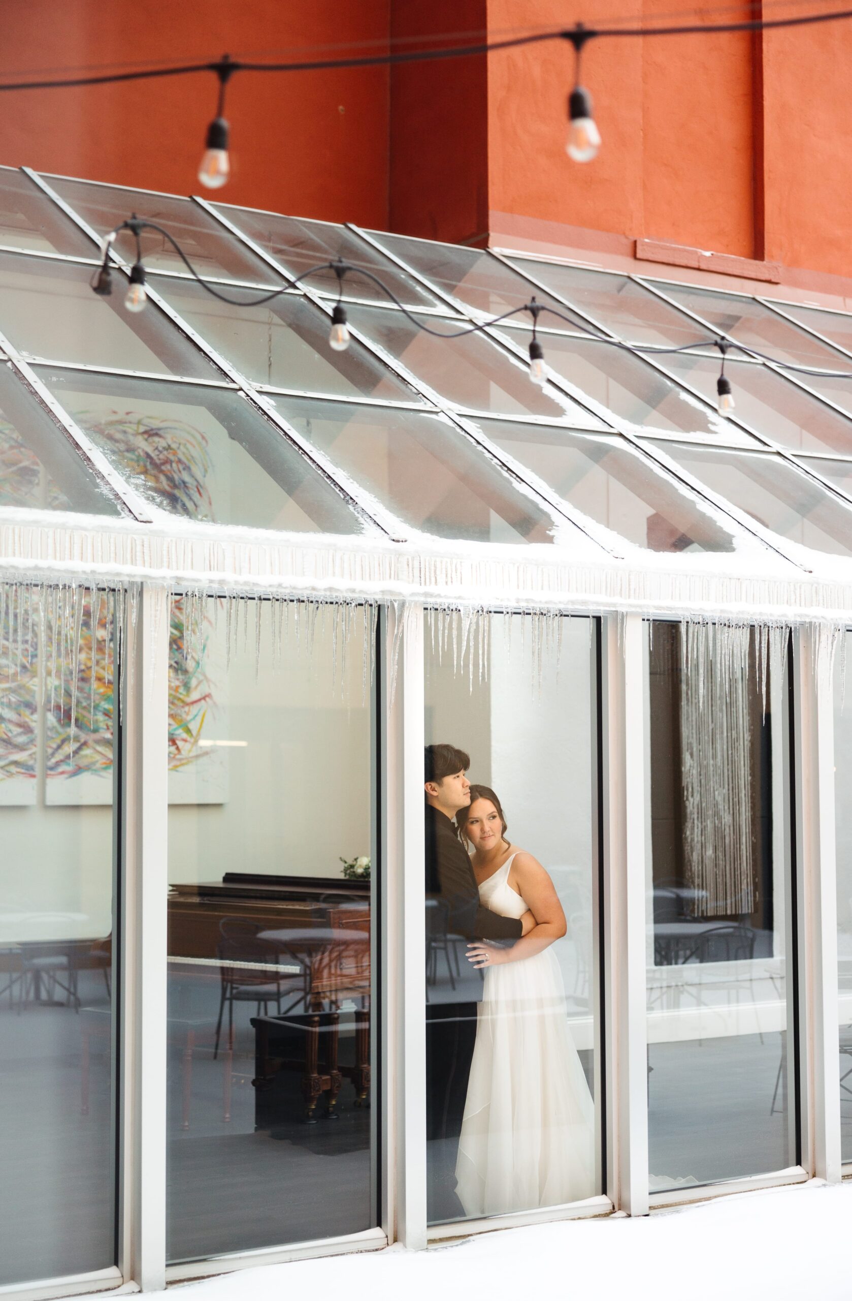 A bride and groom smiles for a wedding photo at the Dayton Arcade.