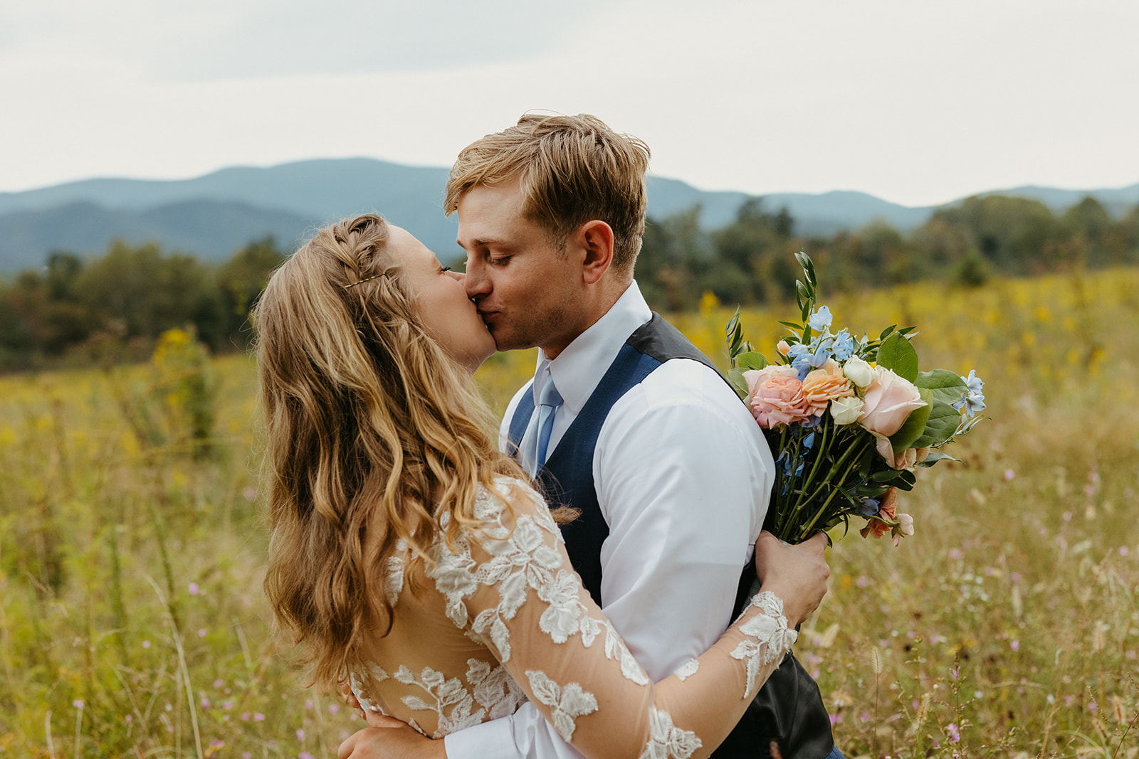 A bride and groom kiss at their wedding at Spence Cabin in the Smoky Mountains.