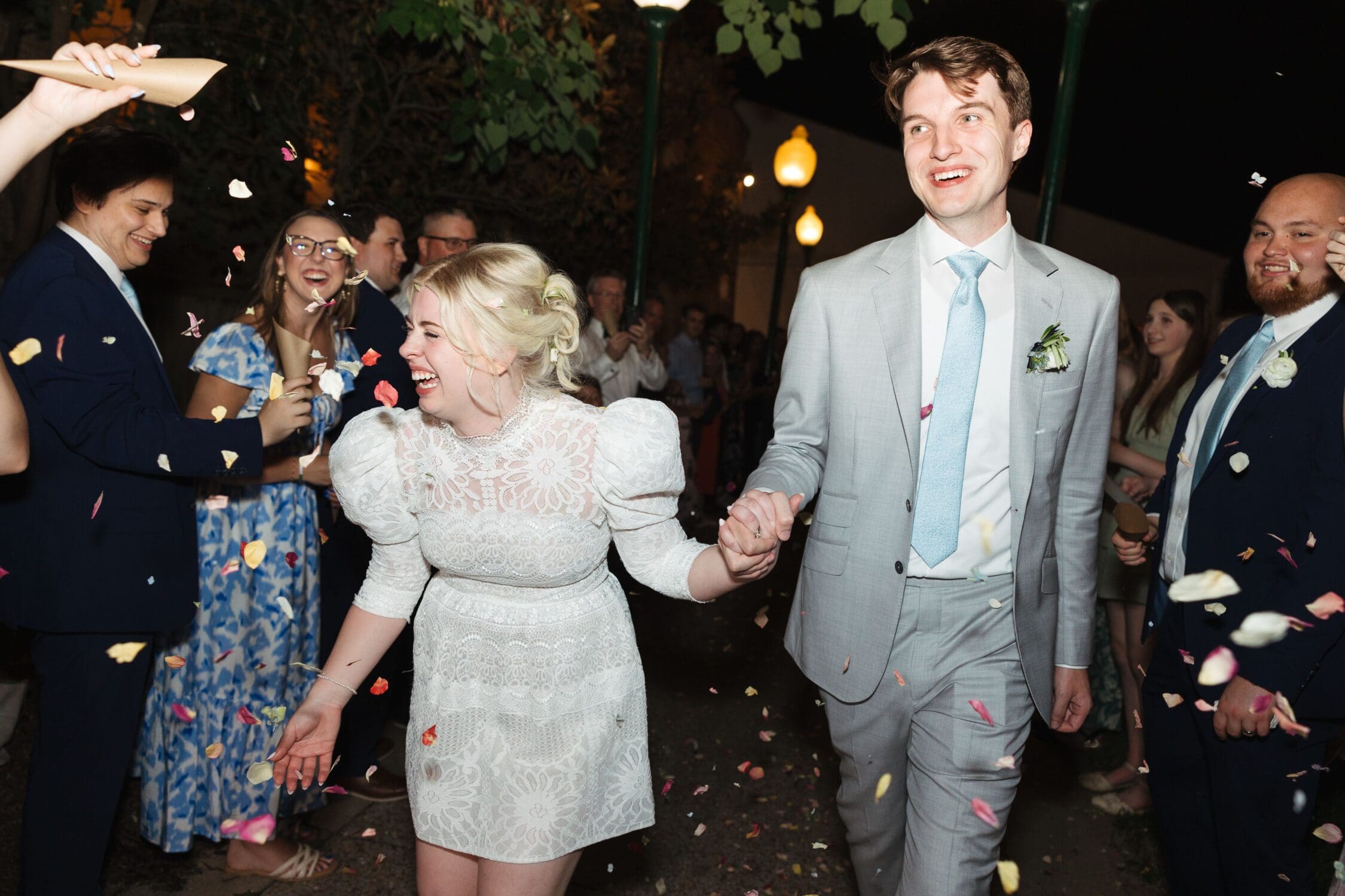 A bride & groom smile leaving their wedding at Riverwood Mansion.