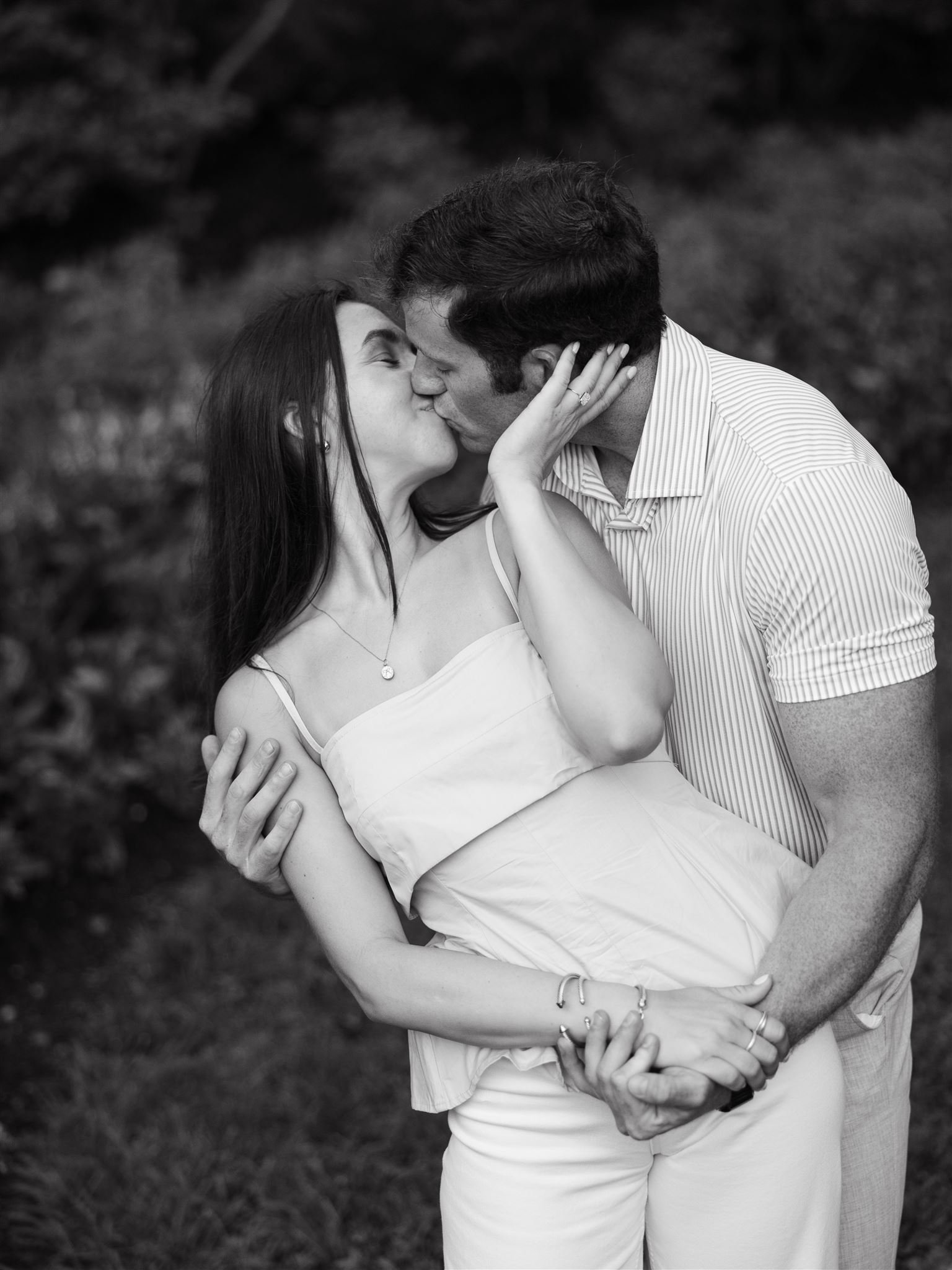 A couple kisses for a photo at Centennial Park in Nashville, Tennessee.